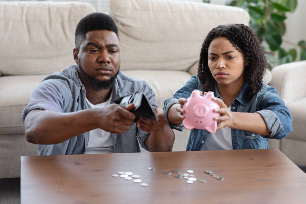 african american counting change after excessive spending