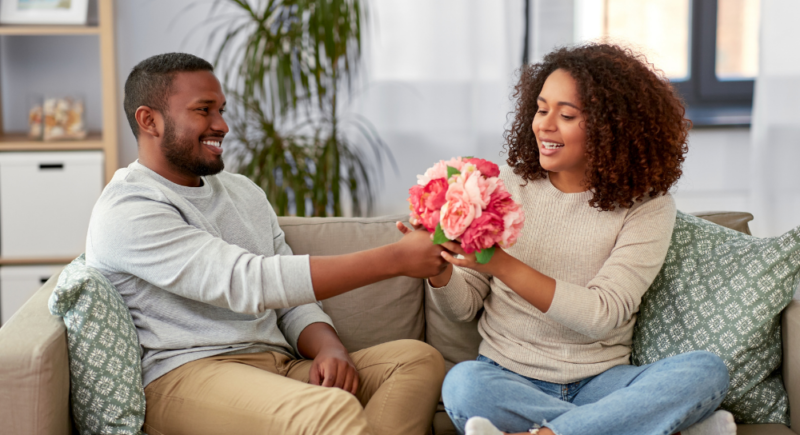 couple exchanging gifts using money hacks