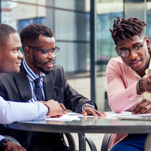 Young Nigerian professionals networking at a career event to land their first job