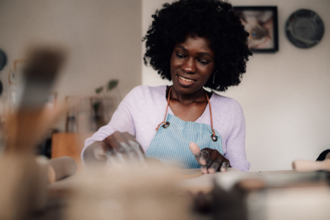 oung woman learning how to be financially independent from parents by running a home baking business as a side hustle while maintaining a steady job